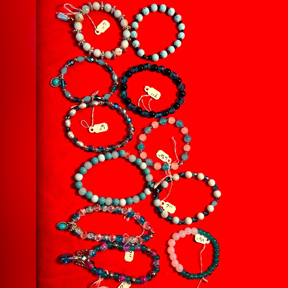 Bracelets all different shades of teal, each one stretchy and range from 6”-7”
